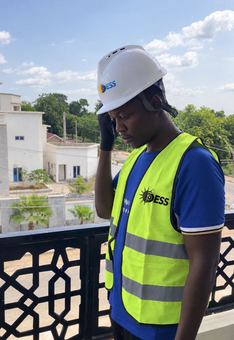 DESS technician on site wearing a safety helmet and high-visibility vest